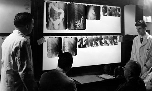 Paul Hodges views x-rays in 1950.