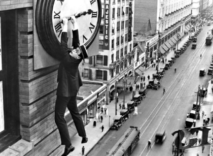 Film still: Harold Lloyd dangling from clock