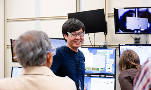 Jung Ho Kim in front of screens